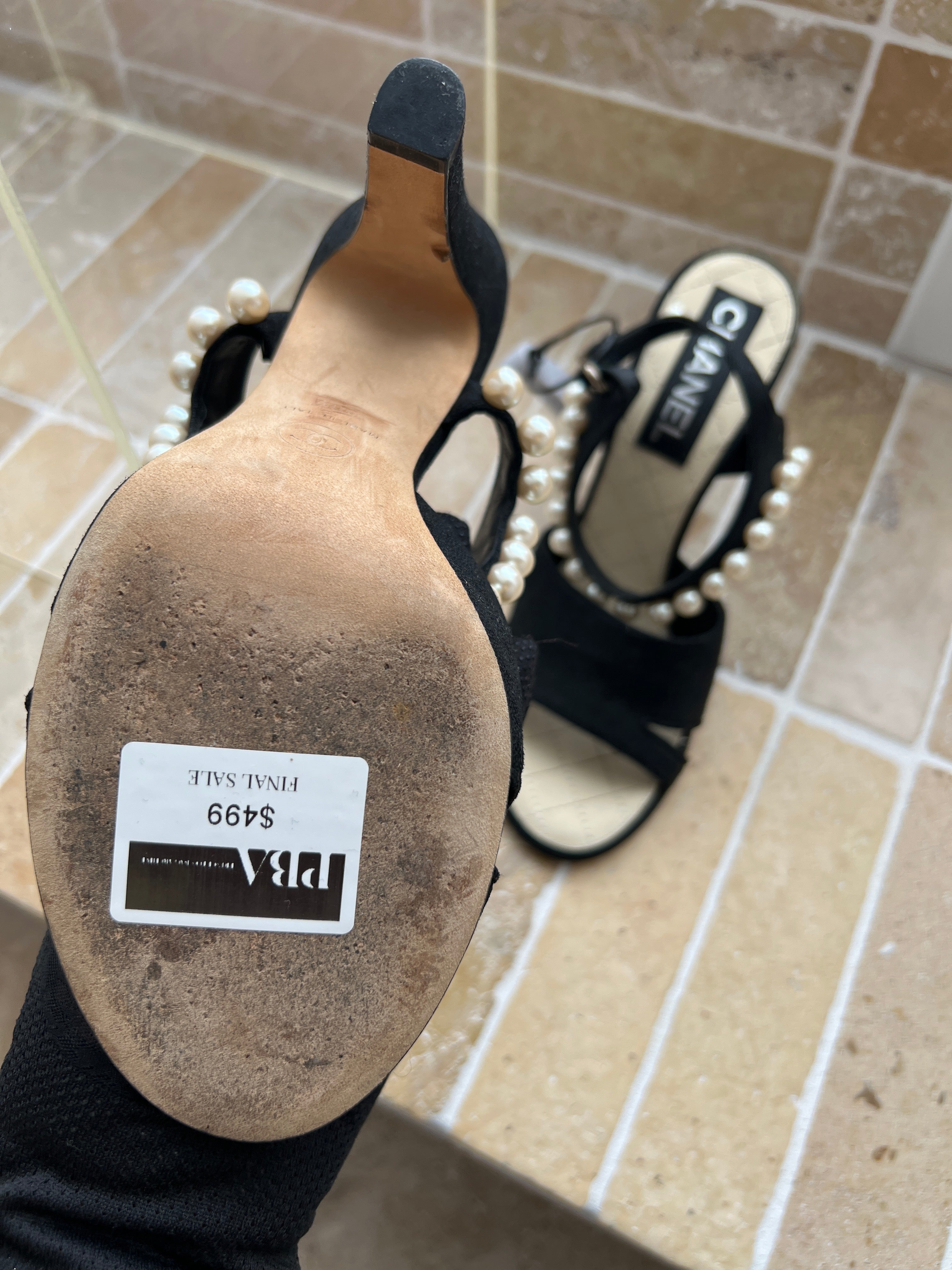 Chanel black suede sandals featuring distinctive faux-pearl embellishments
