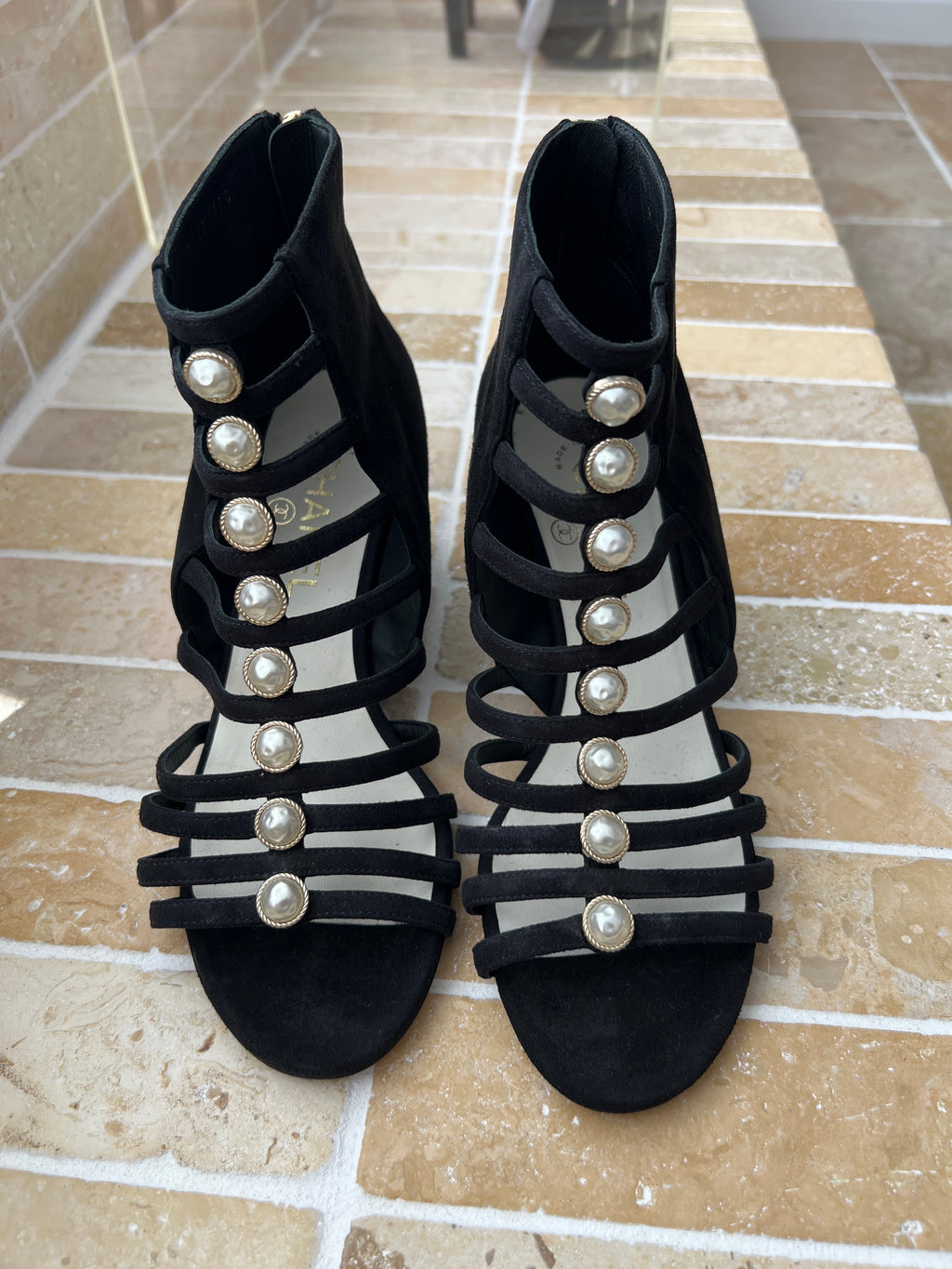 Chanel black strappy heels featuring decorative pearl embellishments