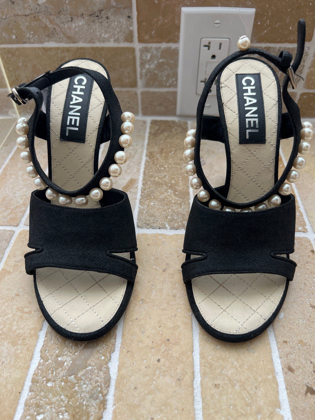 Chanel black suede sandals featuring distinctive faux-pearl embellishments