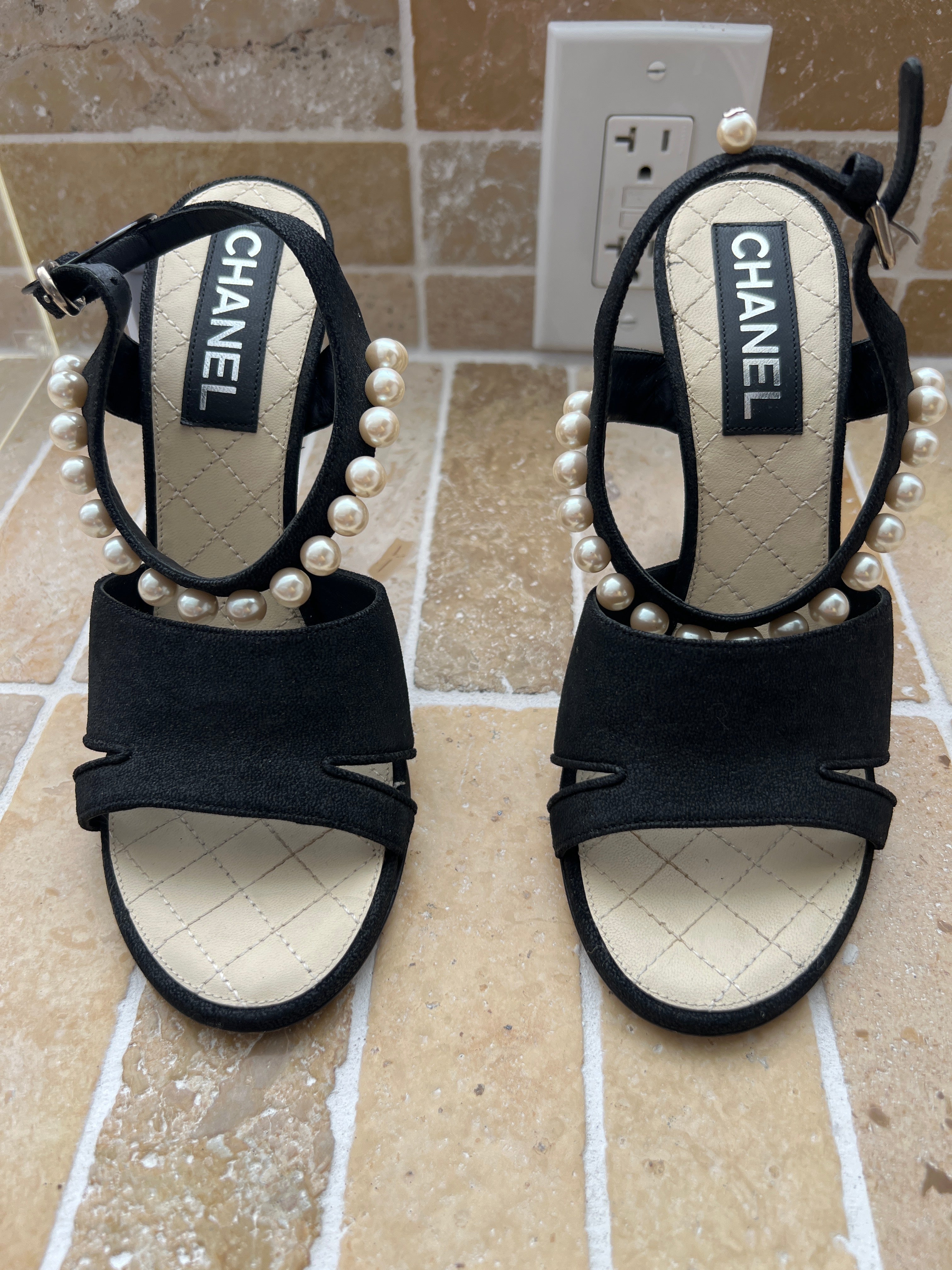 Chanel black suede sandals featuring distinctive faux-pearl embellishments